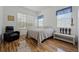 Cozy bedroom featuring hardwood floors, neutral decor, and lots of natural light at 1710 Bridgets Ct, Kissimmee, FL 34744