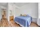 Comfortable bedroom featuring laminate wood flooring, closet and attached bathroom at 1710 Bridgets Ct, Kissimmee, FL 34744