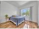 Bright bedroom with hardwood floors, a large window, and a cozy bed at 1710 Bridgets Ct, Kissimmee, FL 34744