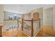 Bright upstairs foyer with wood floors, white railing and arched windows provides a comforting ambiance at 1710 Bridgets Ct, Kissimmee, FL 34744