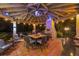 A cozy gazebo with a brick fireplace, outdoor seating, a bar, and colorful lights at 1710 Bridgets Ct, Kissimmee, FL 34744
