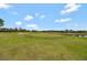 Beautiful golf course view featuring a large green and picturesque pond at 1710 Bridgets Ct, Kissimmee, FL 34744