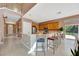 Open-concept kitchen with island seating, stainless appliances, and light wood cabinetry at 1710 Bridgets Ct, Kissimmee, FL 34744