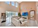 Bright living room with soaring ceilings, large windows and a view of the backyard pool at 1710 Bridgets Ct, Kissimmee, FL 34744