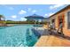 Luxury pool featuring a swim-up bar and hot tub. An outdoor golf course is in view at 1710 Bridgets Ct, Kissimmee, FL 34744