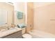 Bathroom featuring granite vanity, tile floors, and shower-tub combination, offering a clean design at 1802 Coriander Dr, Kissimmee, FL 34759