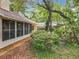 Lush backyard with screened-in porch and mature trees offers a private outdoor space at 1869 Eagles Rest Dr, Apopka, FL 32712
