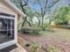 Secluded backyard with mature trees and lush landscaping offers a private outdoor retreat at 1869 Eagles Rest Dr, Apopka, FL 32712