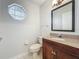 Half bathroom featuring modern fixtures, granite countertops and a tile floor at 1869 Eagles Rest Dr, Apopka, FL 32712