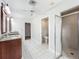 Bright bathroom with double vanity, tile floor and glass enclosed shower at 1869 Eagles Rest Dr, Apopka, FL 32712