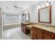 Bright bathroom featuring a soaking tub, tile flooring, and double vanity with granite countertops at 1869 Eagles Rest Dr, Apopka, FL 32712