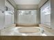 Bathroom featuring soaking tub with jets and three windows at 1869 Eagles Rest Dr, Apopka, FL 32712