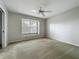 Bedroom with wall-to-wall carpet, neutral walls and large window at 1869 Eagles Rest Dr, Apopka, FL 32712
