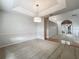 Dining room with tray ceiling and views to the living room at 1869 Eagles Rest Dr, Apopka, FL 32712