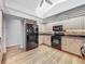 Kitchen featuring wood floors, stainless steel appliances, and light-colored cabinets at 1869 Eagles Rest Dr, Apopka, FL 32712