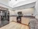 Modern kitchen featuring stainless steel appliances, wood floors, and neutral cabinetry at 1869 Eagles Rest Dr, Apopka, FL 32712
