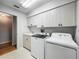 Well-lit laundry room includes sink, plentiful cabinet space, and modern washer and dryer at 1869 Eagles Rest Dr, Apopka, FL 32712