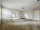 Neutral living room with ceiling fan, crown molding, and ample sunlight at 1869 Eagles Rest Dr, Apopka, FL 32712