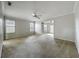 Large living room with neutral carpet, ceiling fan, and lots of natural light at 1869 Eagles Rest Dr, Apopka, FL 32712