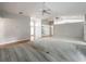 Bright and spacious living room featuring wood flooring, carpet, and multiple ceiling fans at 1869 Eagles Rest Dr, Apopka, FL 32712