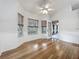 Sunlit living room features hardwood floors, large windows, and paneled walls at 1869 Eagles Rest Dr, Apopka, FL 32712