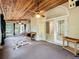 Spacious sunroom with wood plank ceiling, arched doorways, and wicker furniture at 1869 Eagles Rest Dr, Apopka, FL 32712