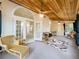 Expansive sunroom with a decorative wood ceiling, and access to the backyard at 1869 Eagles Rest Dr, Apopka, FL 32712