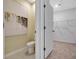 Powder room and open closet space featuring a modern painting and neutral tones at 203 Taylor Groves Dr, Lake Wales, FL 33853