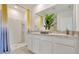 Well-lit bathroom featuring a double vanity, granite countertop, and a walk-in shower at 203 Taylor Groves Dr, Lake Wales, FL 33853