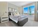 Serene bedroom with a large window, gray bedding, side table, and plenty of natural light at 203 Taylor Groves Dr, Lake Wales, FL 33853