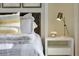 Beautifully styled bedroom features elegant bedding and a modern lamp on a nightstand at 203 Taylor Groves Dr, Lake Wales, FL 33853