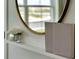 Cozy bookshelf features a mirror, flower arrangement and two hardcover books at 203 Taylor Groves Dr, Lake Wales, FL 33853