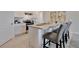 Well-lit kitchen with a kitchen island and bar stools, showcasing modern appliances and ample countertop space at 203 Taylor Groves Dr, Lake Wales, FL 33853