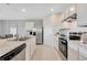 Bright kitchen featuring stainless steel appliances, white cabinets, and sleek countertops for a modern look at 203 Taylor Groves Dr, Lake Wales, FL 33853