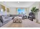 Comfortable living room featuring plush sectional sofa, a large window, and stylish decor at 203 Taylor Groves Dr, Lake Wales, FL 33853