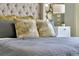 Close-up view of a main bedroom, highlighting the luxurious bedding and stylish decor at 203 Taylor Groves Dr, Lake Wales, FL 33853