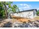 View of the home's exterior featuring a spacious backyard area and white stucco siding at 2105 9Th Ne St, Winter Haven, FL 33880
