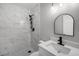 Updated bathroom featuring shower with tile surround, modern sink, and black hardware at 2105 9Th Ne St, Winter Haven, FL 33880