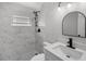 Modern bathroom featuring white marble tile, modern vanity and shower fixtures at 2105 9Th Ne St, Winter Haven, FL 33880