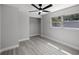 Spacious bedroom with large window, ceiling fan and vinyl flooring; a simple, comfortable design at 2105 9Th Ne St, Winter Haven, FL 33880