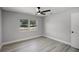 Bedroom with bright windows, gray walls and gray wood-look flooring at 2105 9Th Ne St, Winter Haven, FL 33880