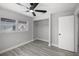 Bedroom with two windows, gray walls, a ceiling fan and a closet at 2105 9Th Ne St, Winter Haven, FL 33880