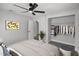 Bedroom with a ceiling fan, neutral walls, and open closet for ample storage at 2105 9Th Ne St, Winter Haven, FL 33880