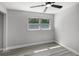 Bedroom with gray walls, wood-look flooring, ceiling fan and natural light from the window at 2105 9Th Ne St, Winter Haven, FL 33880