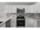 Renovated kitchen with stainless steel appliances, sleek countertops, and modern cabinetry at 2105 9Th Ne St, Winter Haven, FL 33880