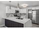 Modern kitchen with stainless steel appliances, a stylish island, and white cabinetry at 2105 9Th Ne St, Winter Haven, FL 33880