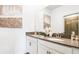 Bright bathroom featuring double sinks, granite countertop, and neutral wall art at 2916 Simile St, Kissimmee, FL 34746