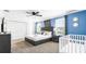 This bedroom features neutral walls, a queen-sized bed with pillows, and a crib at 2916 Simile St, Kissimmee, FL 34746