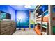 Fun bedroom featuring bunk beds, a dresser, and starry wall decor at 2916 Simile St, Kissimmee, FL 34746