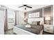 This primary bedroom includes neutral walls, a ceiling fan, and a king-sized bed with gray and white bedding at 2916 Simile St, Kissimmee, FL 34746